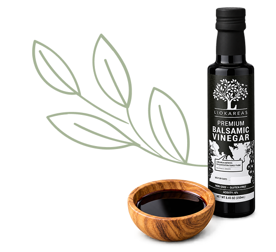 LioKareas premium balsamic vinegar bottle with balsamic vinegar served in a wooden bowl.